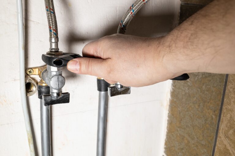 Plumber,hand,installs,water,stop,tap,by,adjustable,wrench,at